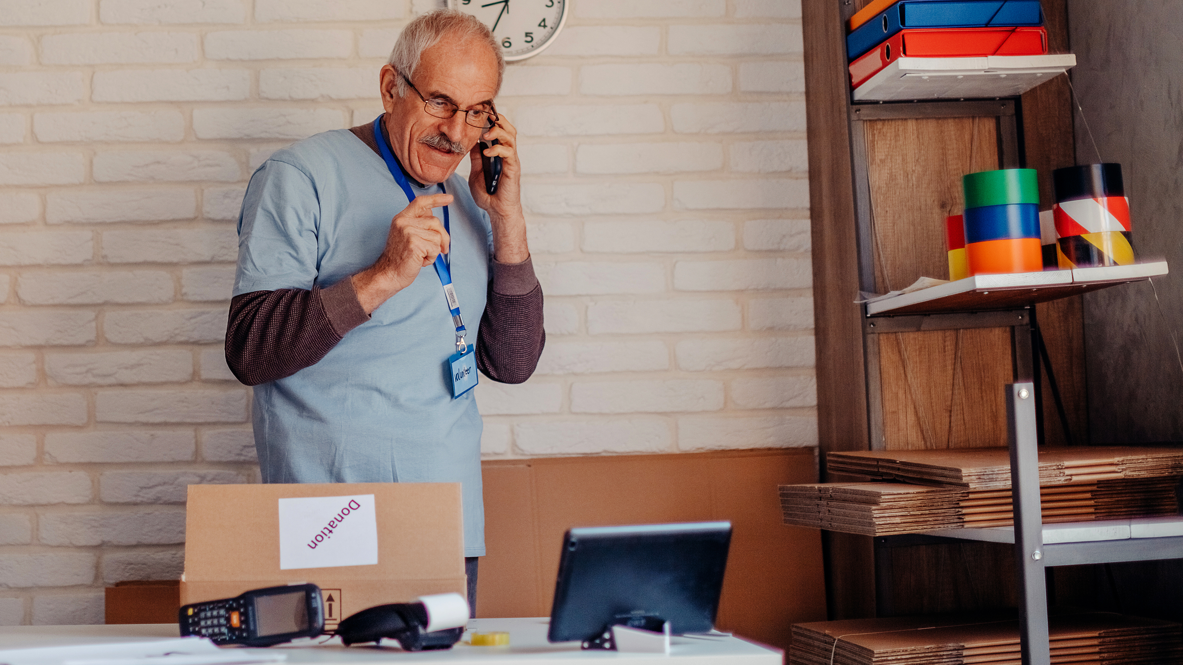 Man on phone looking at tablet